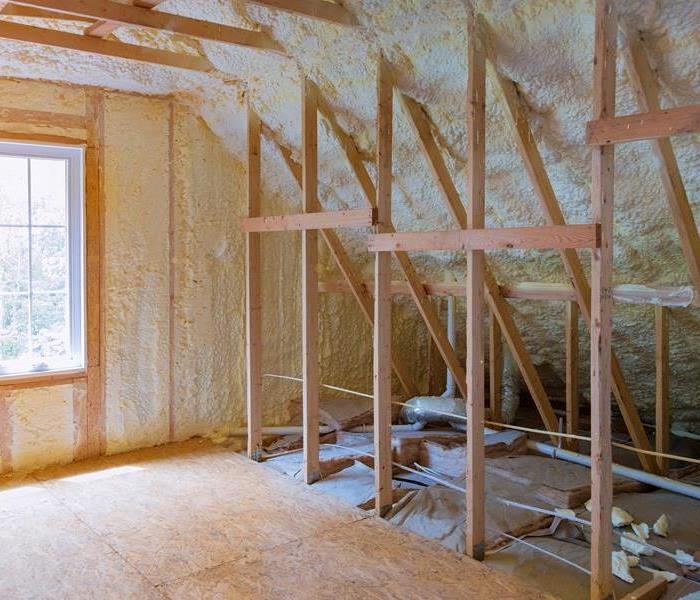 insulation in an attic area being hung 